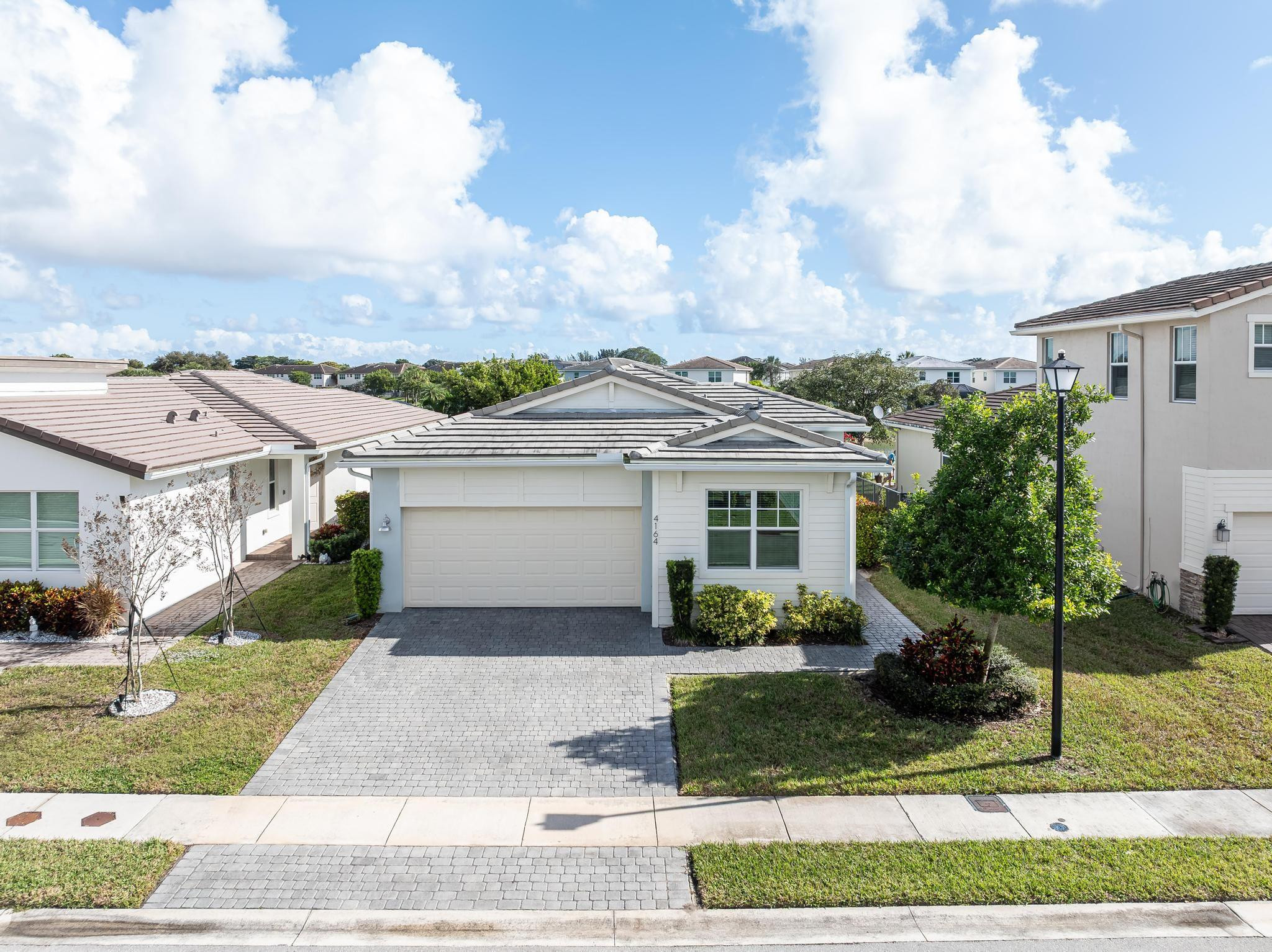 4164 Rosa Drive Deerfield Beach, FL 33064 - Photo 11 of 50 a view of a white house next to a yard