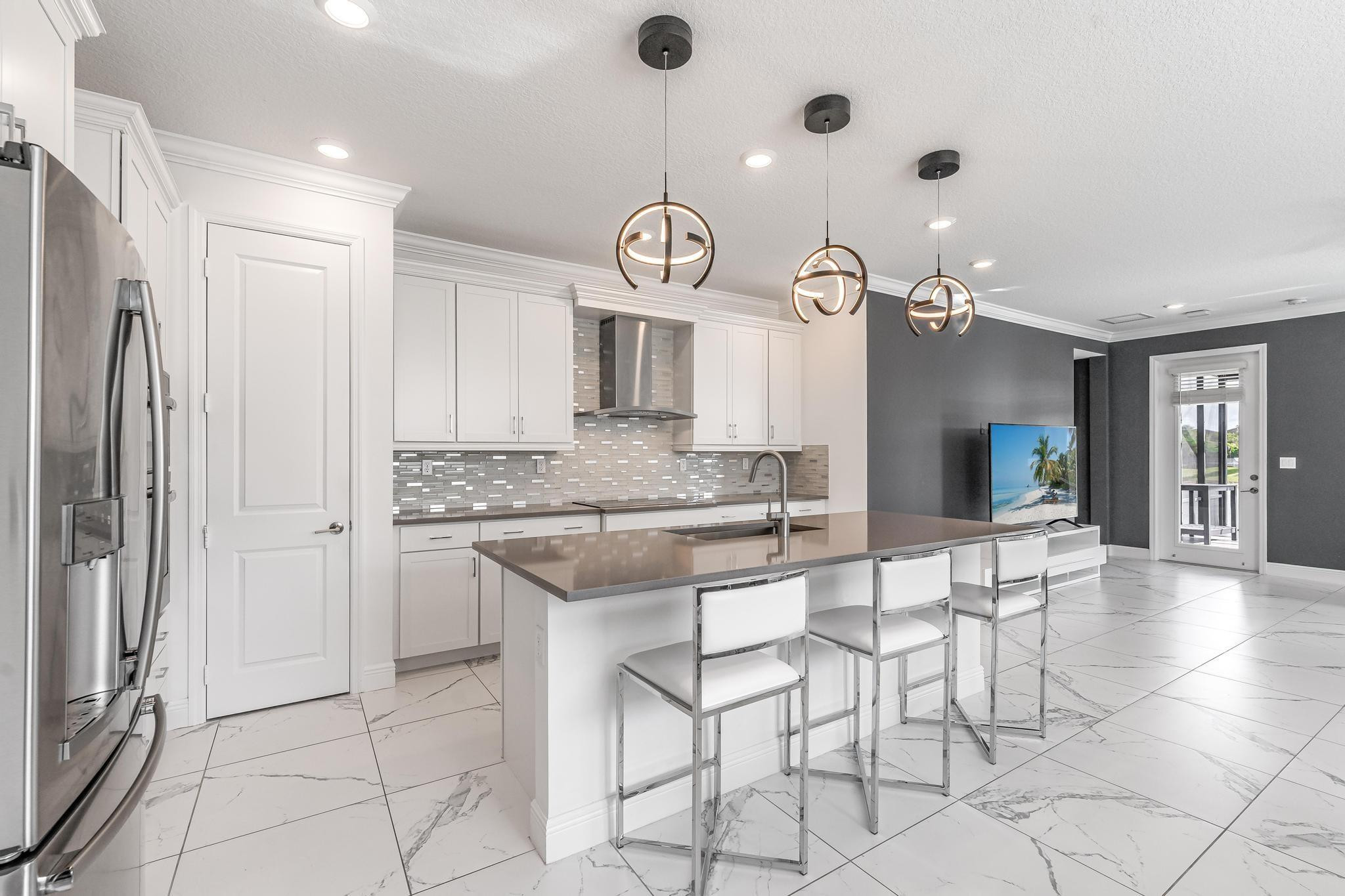 4164 Rosa Drive Deerfield Beach, FL 33064 - Photo 13 of 50 a large kitchen with granite countertop a sink cabinets and stainless steel appliances
