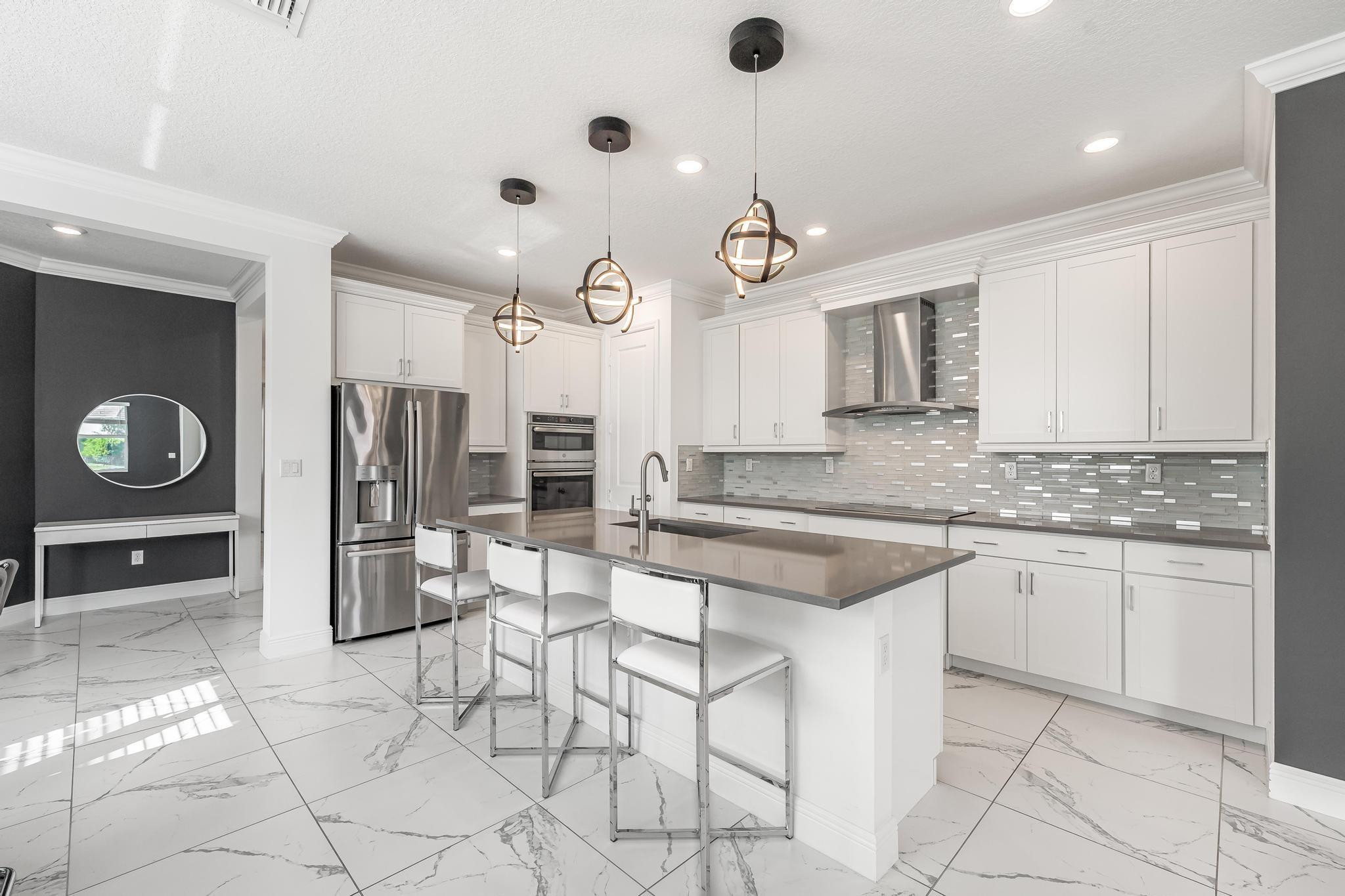 4164 Rosa Drive Deerfield Beach, FL 33064 - Photo 17 of 50 a kitchen with stainless steel appliances granite countertop a sink and cabinets