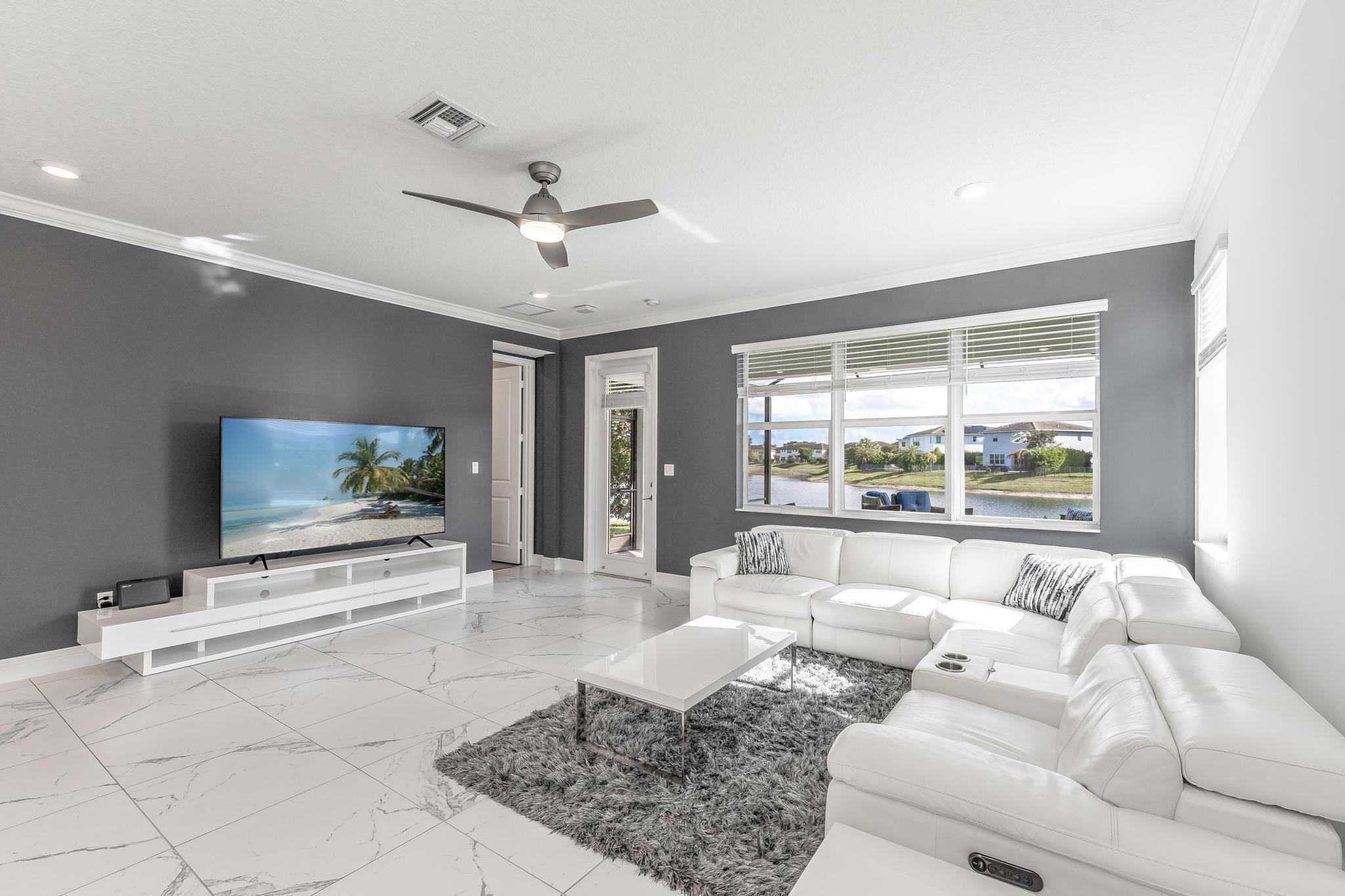 4164 Rosa Drive Deerfield Beach, FL 33064 - Photo 19 of 50 a living room with furniture and a flat screen tv