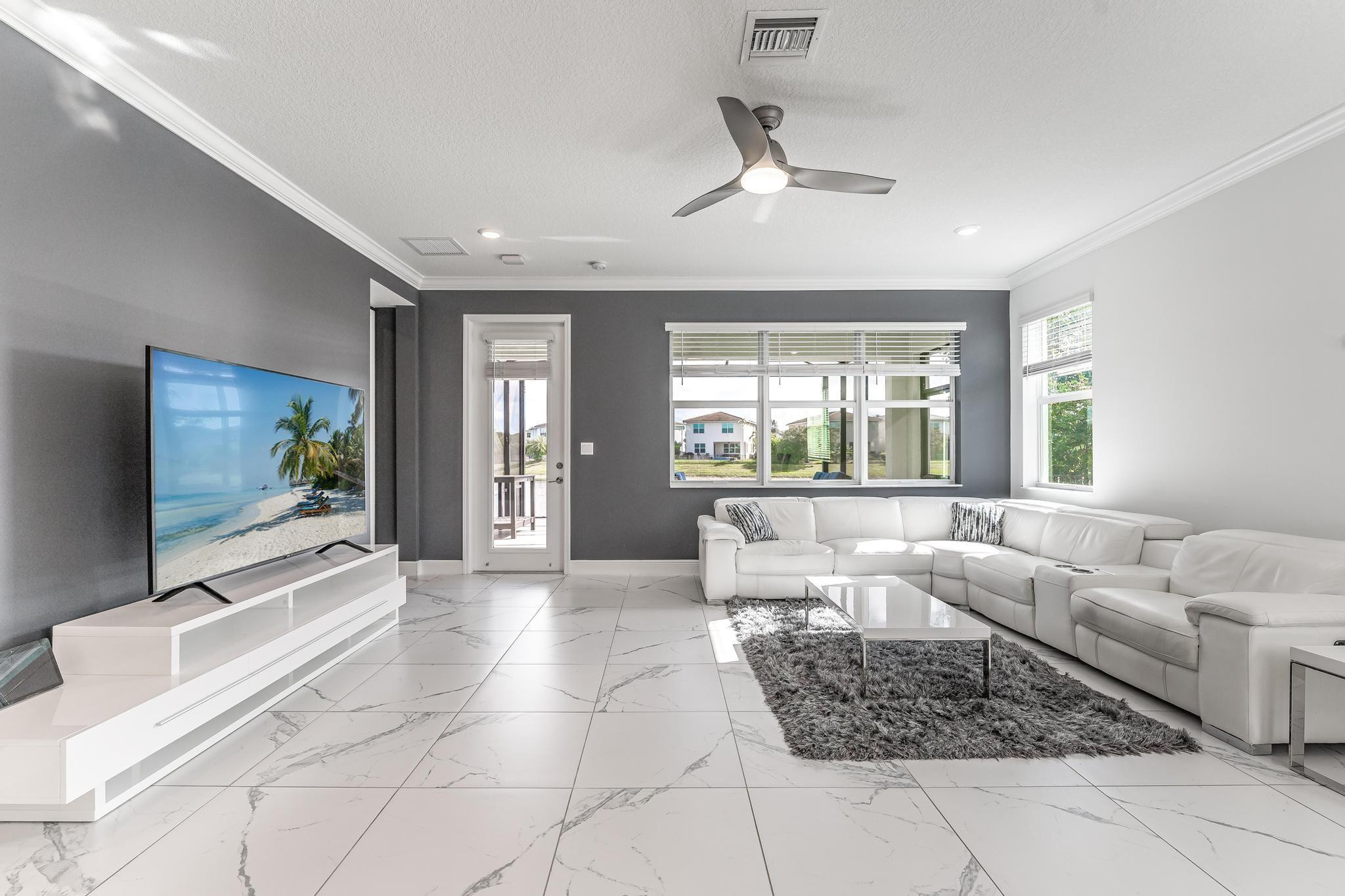 4164 Rosa Drive Deerfield Beach, FL 33064 - Photo 20 of 50 a living room with furniture and a flat screen tv