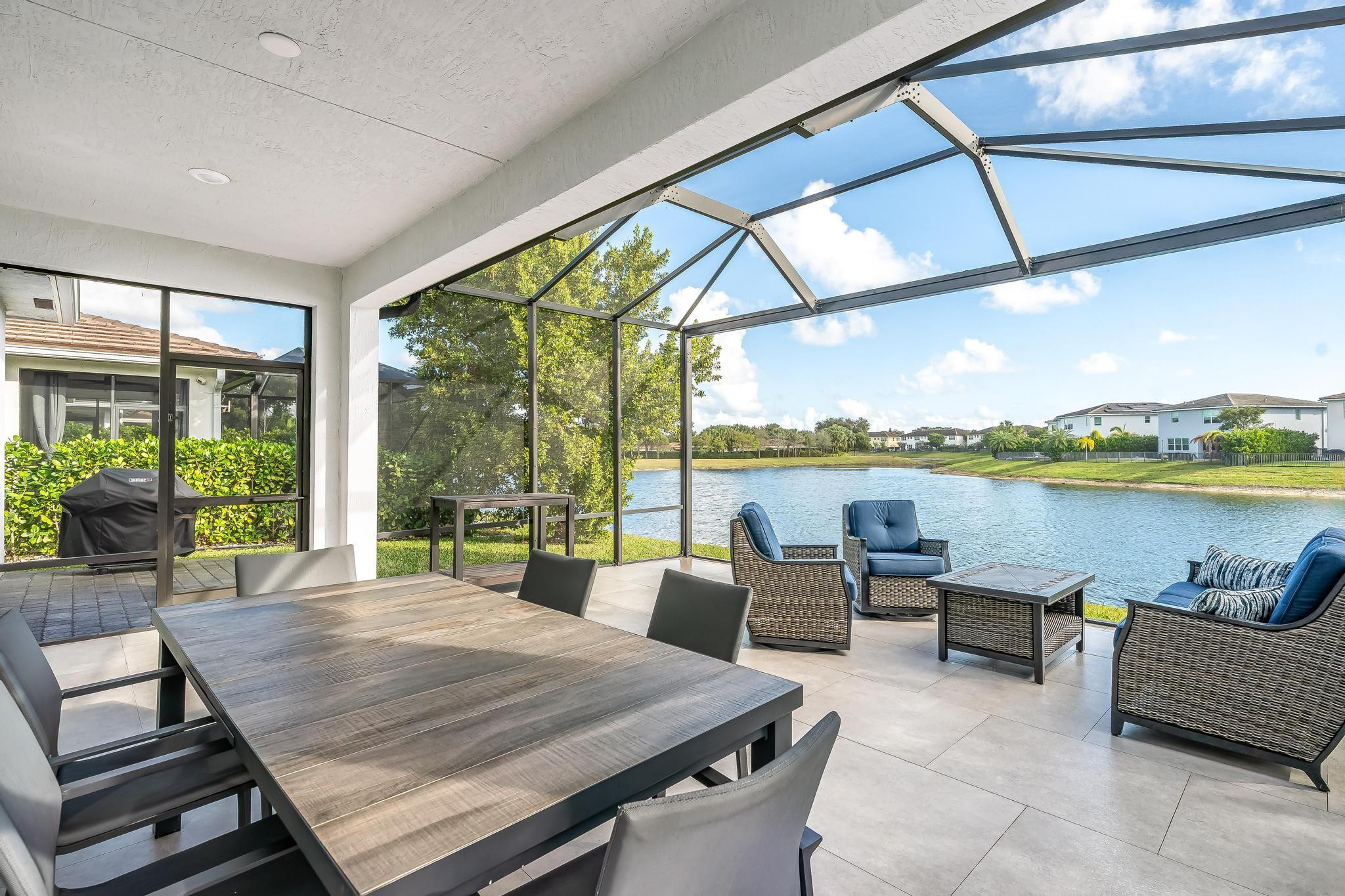 4164 Rosa Drive Deerfield Beach, FL 33064 - Photo 23 of 50 a living room with furniture and a floor to ceiling window