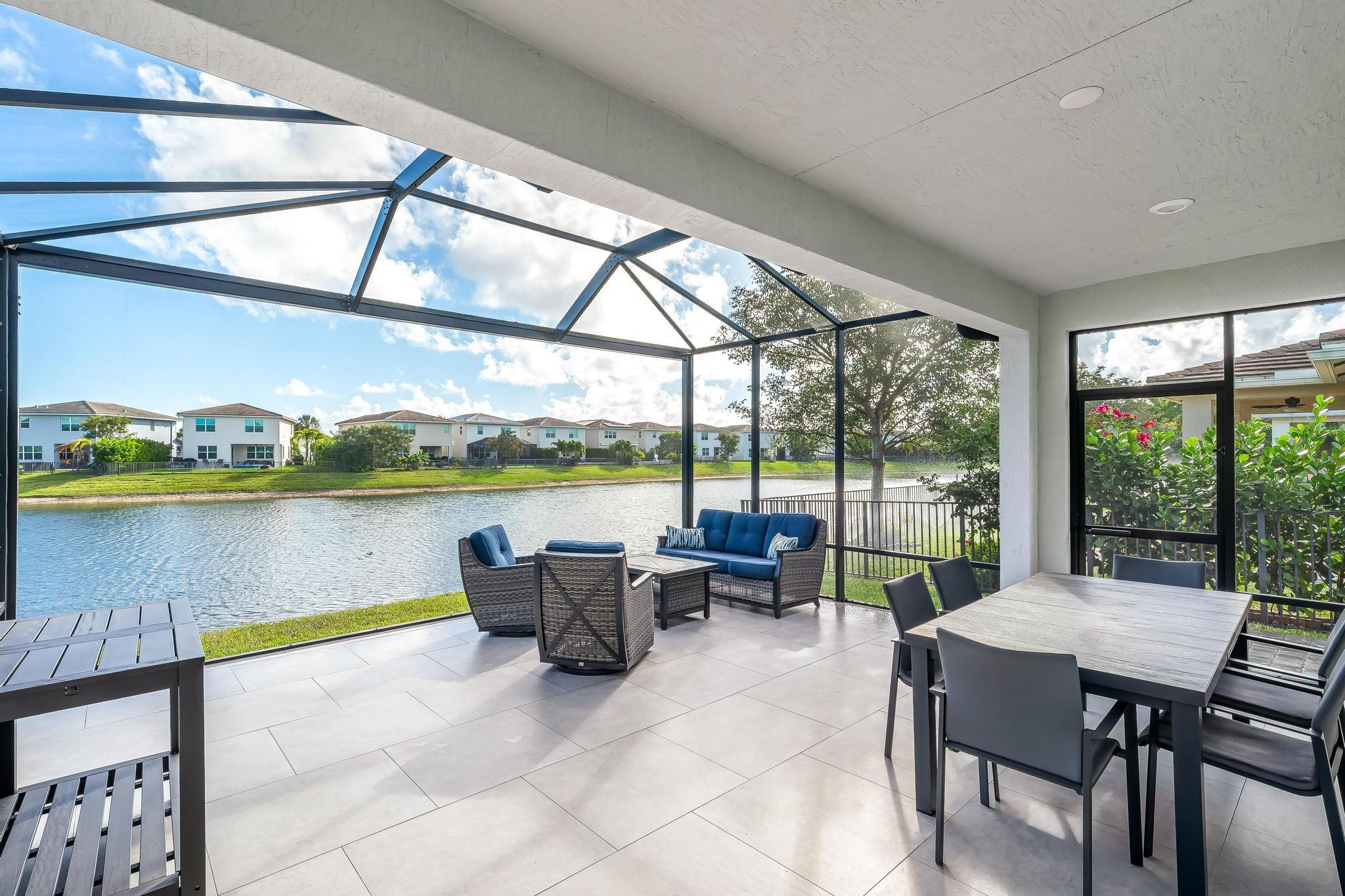 4164 Rosa Drive Deerfield Beach, FL 33064 - Photo 24 of 50 a living room with furniture and floor to ceiling windows
