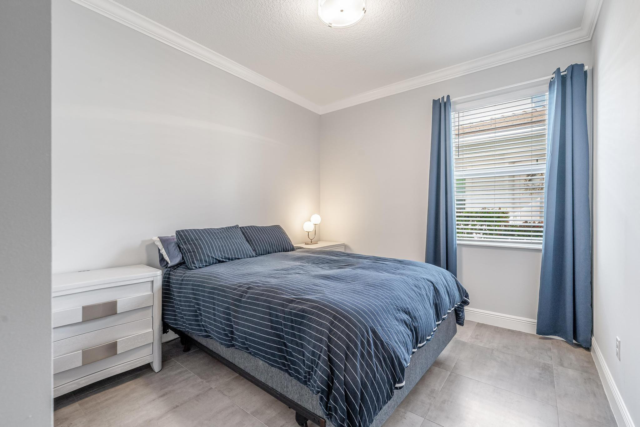 4164 Rosa Drive Deerfield Beach, FL 33064 - Photo 28 of 50 a bedroom with a bed and a window