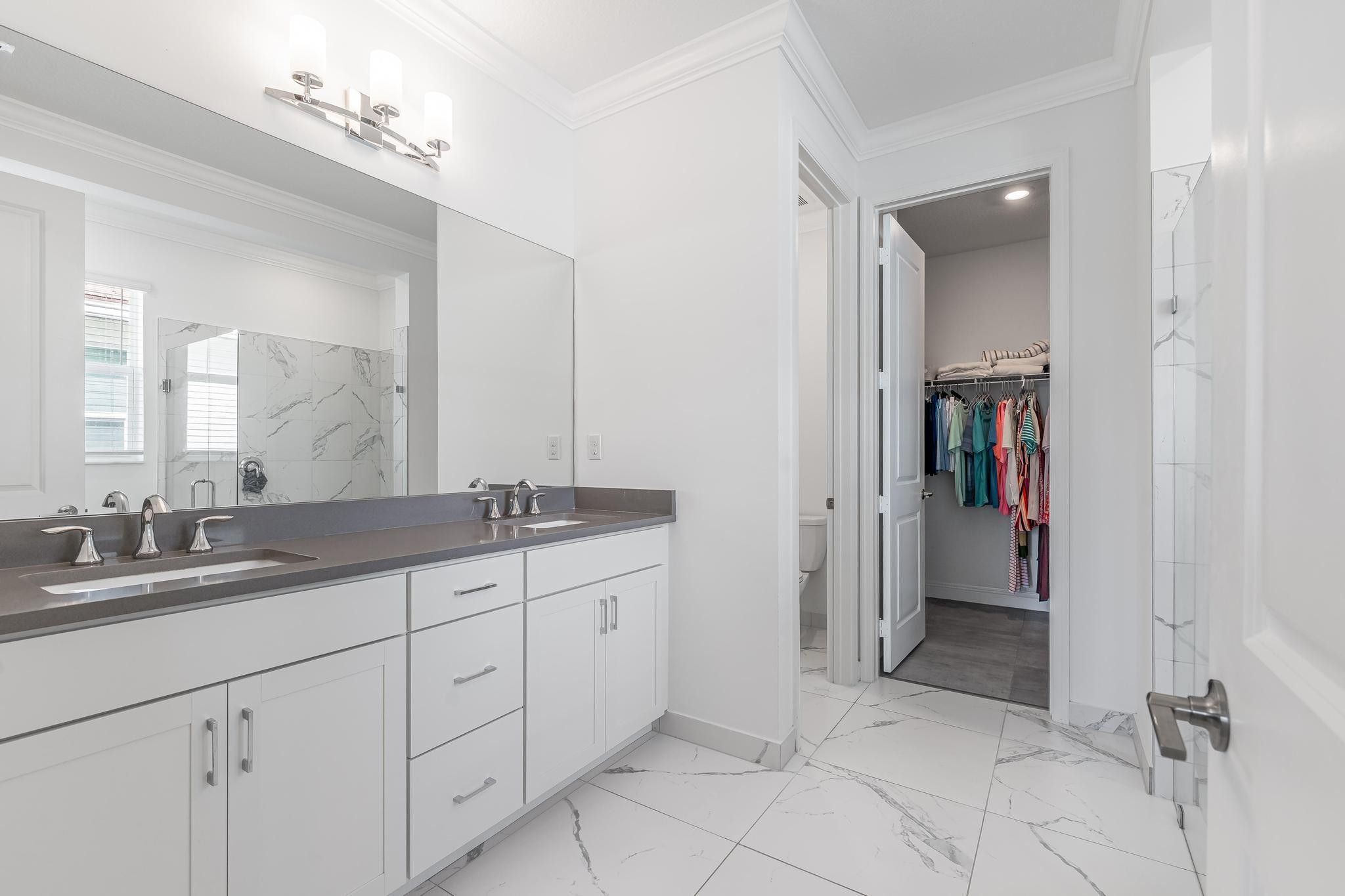 4164 Rosa Drive Deerfield Beach, FL 33064 - Photo 33 of 50 a bathroom with a granite countertop sink two mirror and a vanity
