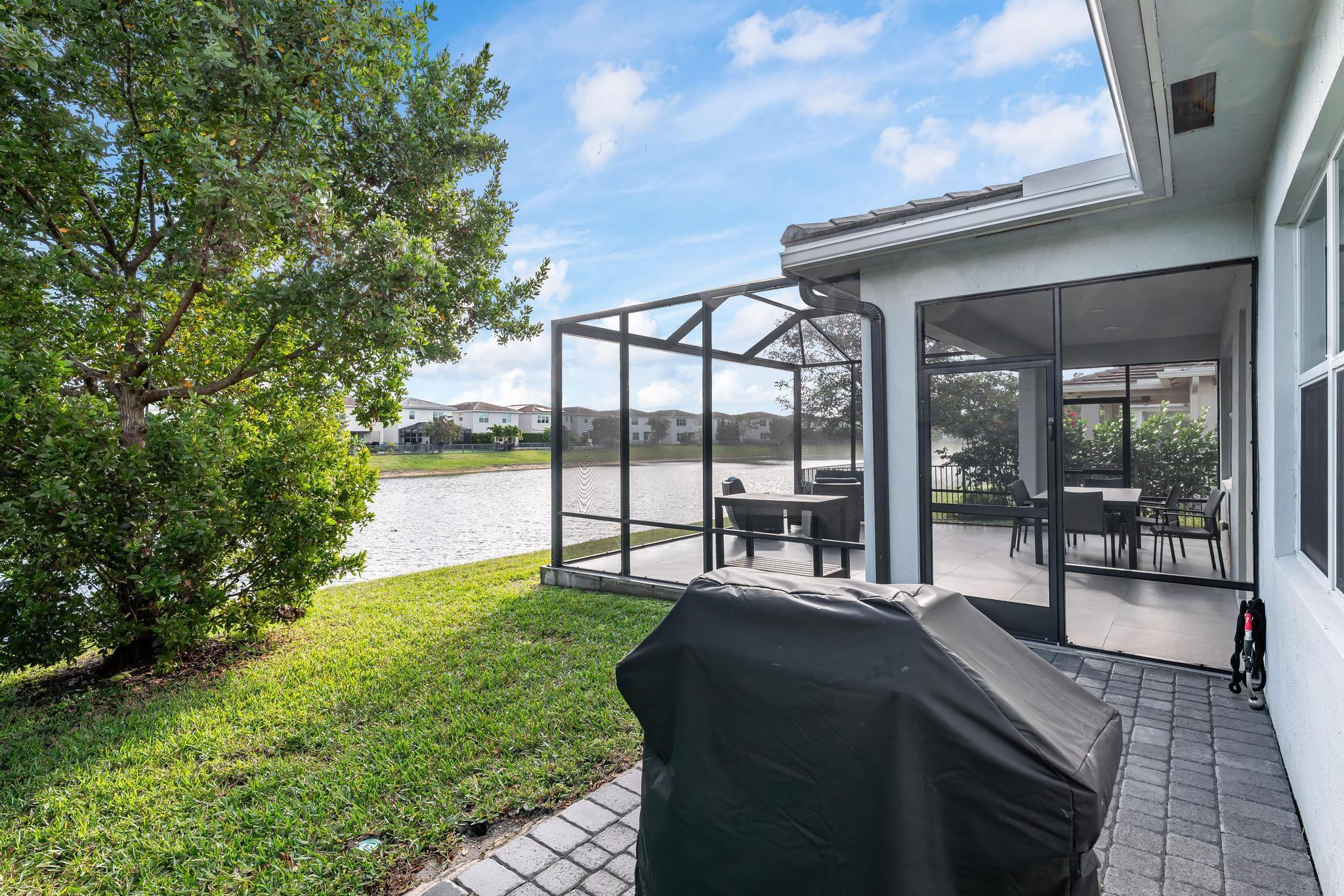 4164 Rosa Drive Deerfield Beach, FL 33064 - Photo 37 of 50 a spacious bedroom with a large window and a table
