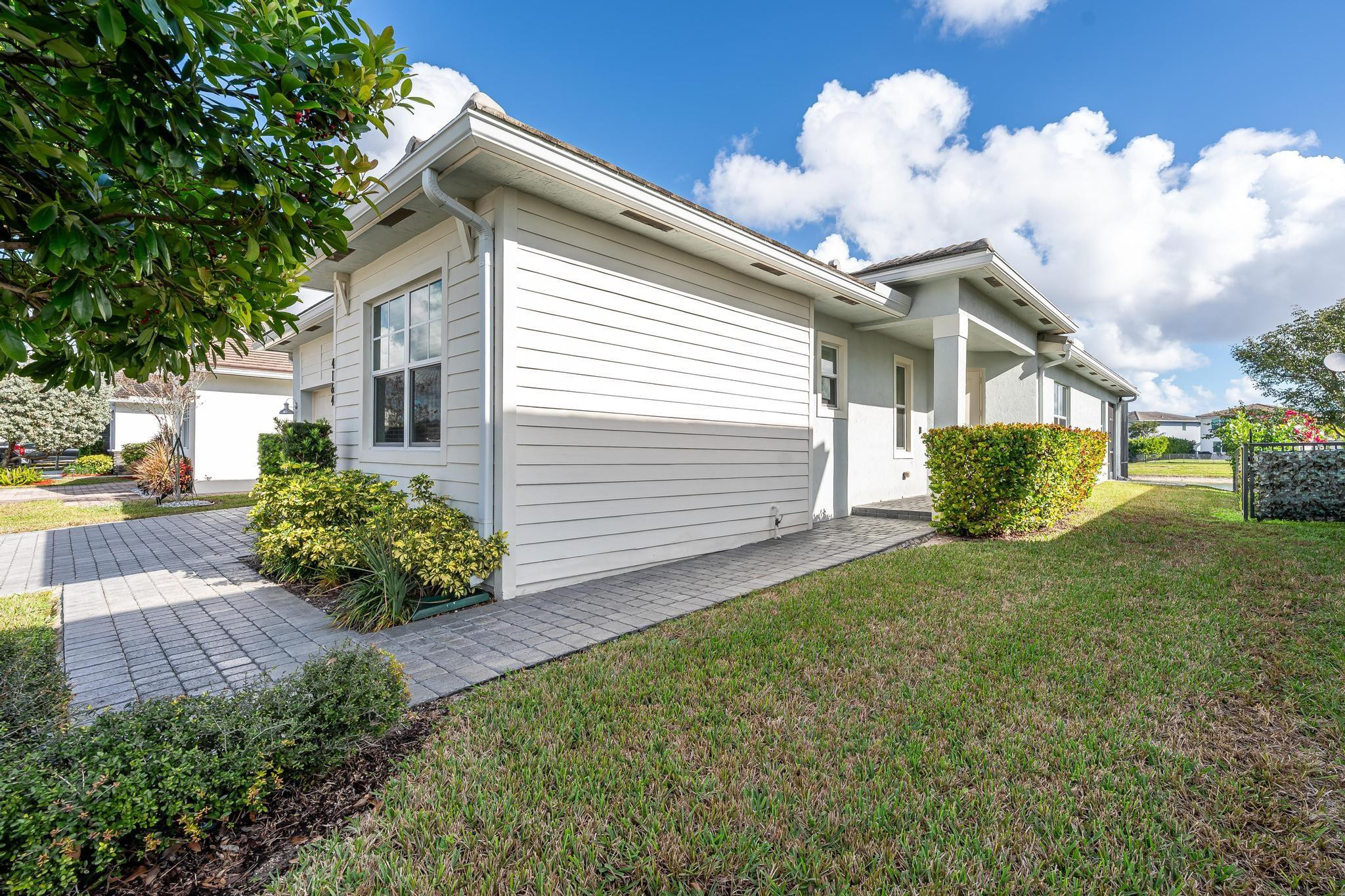 4164 Rosa Drive Deerfield Beach, FL 33064 - Photo 40 of 50 a front view of a house with garden