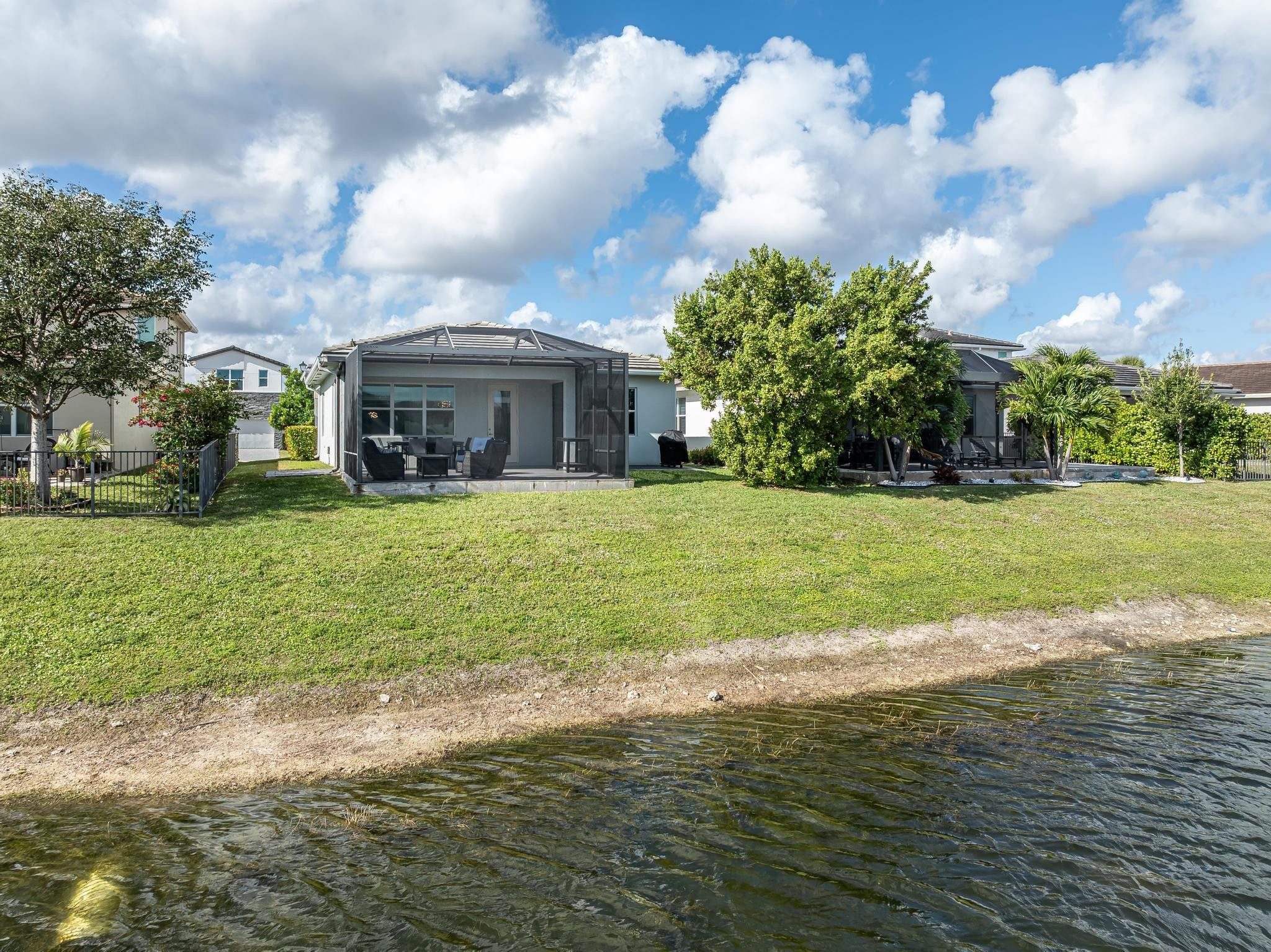 4164 Rosa Drive Deerfield Beach, FL 33064 - Photo 5 of 50 a view of a house with a big yard and large trees