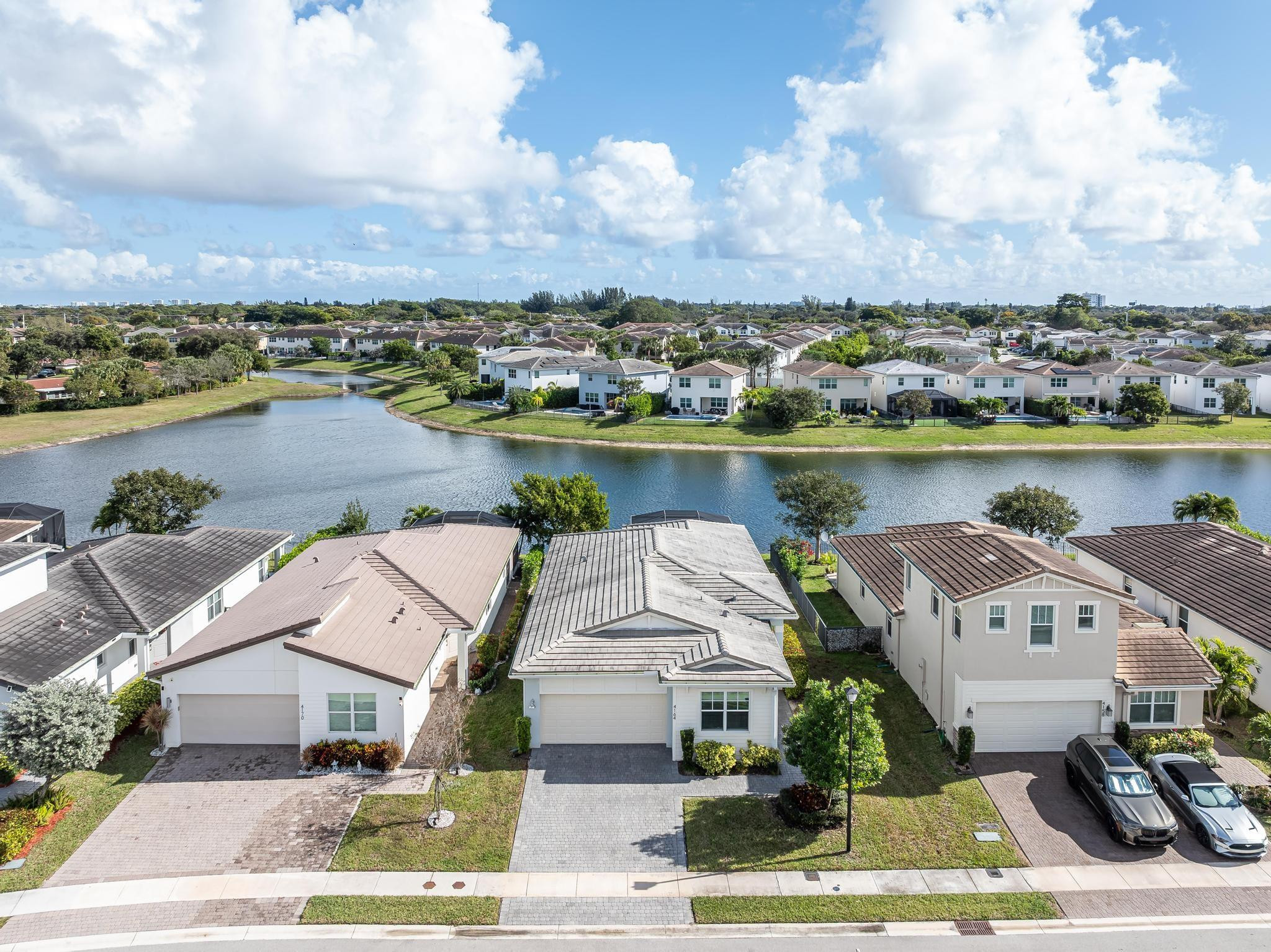 4164 Rosa Drive Deerfield Beach, FL 33064 - Photo 9 of 50 an aerial view of a house with a lake and houses in the back