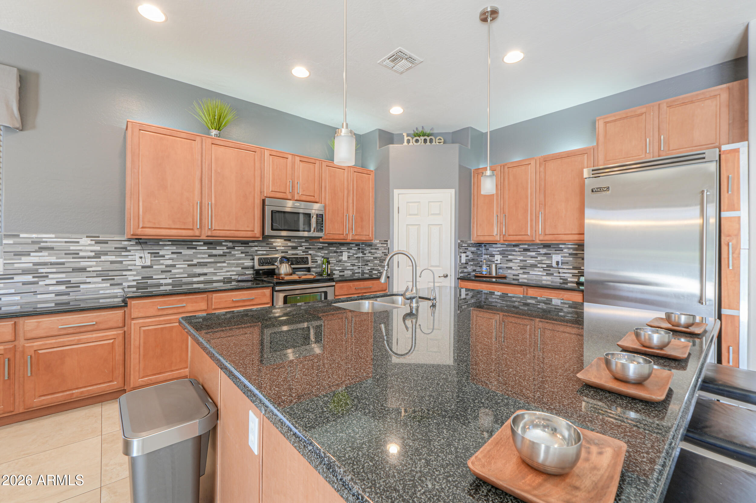 45247 West Jack Rabbit Trail Maricopa, AZ 85139 - Photo 16 of 75 a kitchen with stainless steel appliances granite countertop a sink refrigerator and microwave
