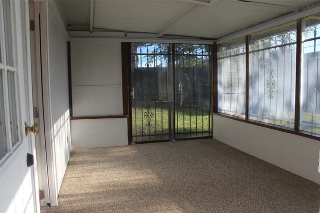 a view of empty room with wooden walls