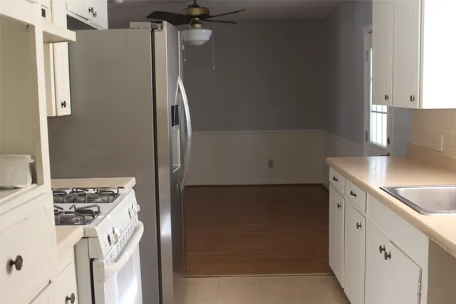 a kitchen with a refrigerator stove and sink