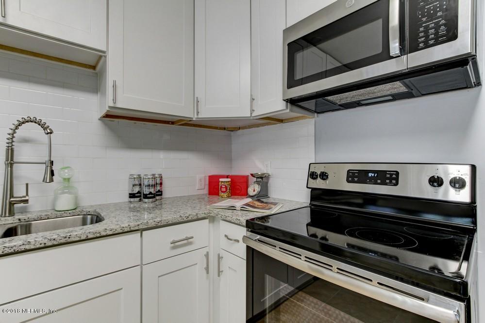 2241 Bayview Road Jacksonville, FL 32210 - Photo 30 of 55 a kitchen with granite countertop a stove microwave and sink