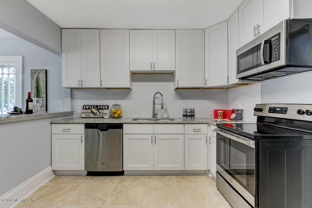 2241 Bayview Road Jacksonville, FL 32210 - Photo 31 of 55 a kitchen with stainless steel appliances granite countertop a sink stove and microwave