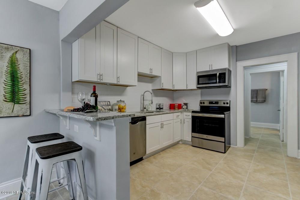 2241 Bayview Road Jacksonville, FL 32210 - Photo 33 of 55 a kitchen with stainless steel appliances a stove sink microwave and cabinets