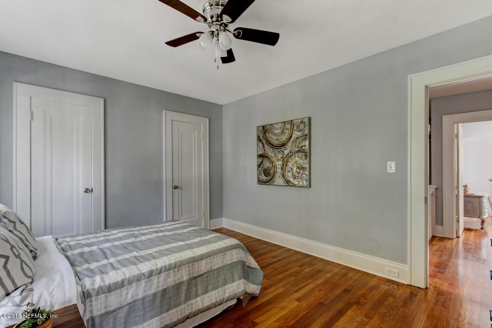 2241 Bayview Road Jacksonville, FL 32210 - Photo 44 of 55 a bedroom with a large bed and a chandelier
