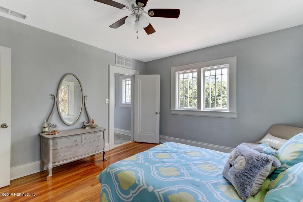 2241 Bayview Road Jacksonville, FL 32210 - Photo 50 of 55 a bedroom with a bed a dresser and wooden floor