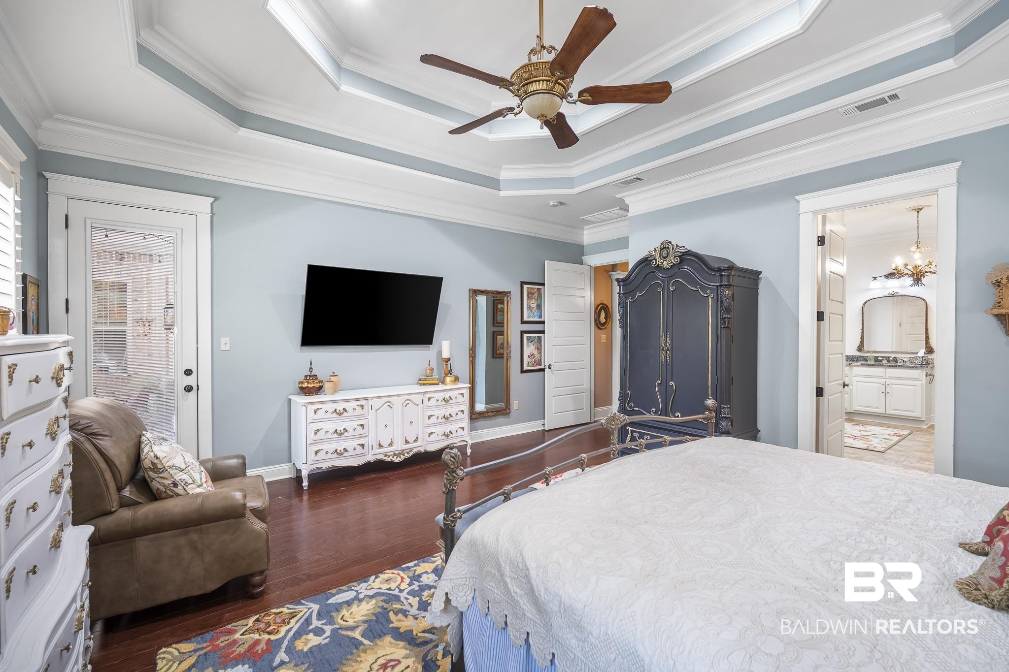 25212 Austin Road Daphne, AL 36526 - Photo 29 of 56 Bedroom with a tray ceiling, ensuite bathroom, crown molding, dark wood-type flooring, and ceiling fan