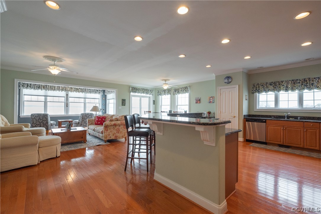 580 Riverside Drive Lancaster, VA 22503 - Photo 11 of 50 a living room with furniture a wooden floor and a large window