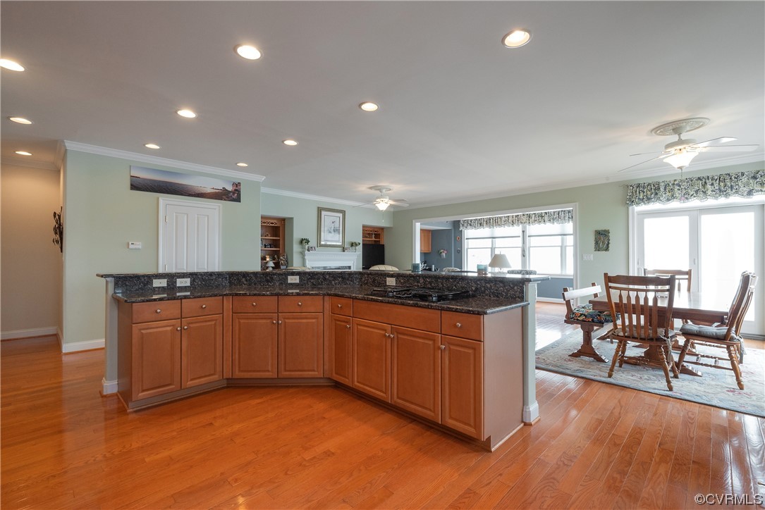 580 Riverside Drive Lancaster, VA 22503 - Photo 14 of 50 a large kitchen with stainless steel appliances granite countertop a lot of counter space and wooden floors