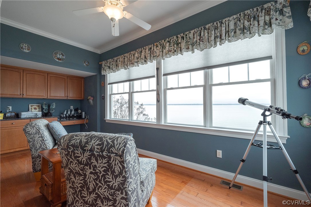 580 Riverside Drive Lancaster, VA 22503 - Photo 21 of 50 a living room with furniture and a floor to ceiling window