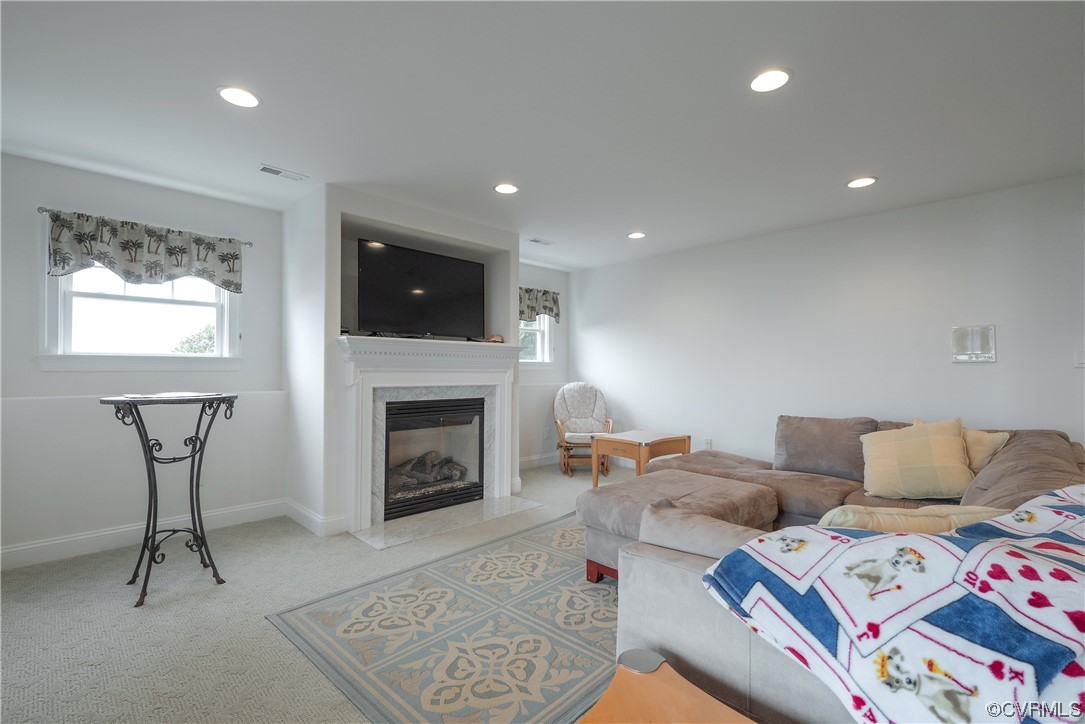 580 Riverside Drive Lancaster, VA 22503 - Photo 29 of 50 a living room with furniture a flat screen tv and a fireplace