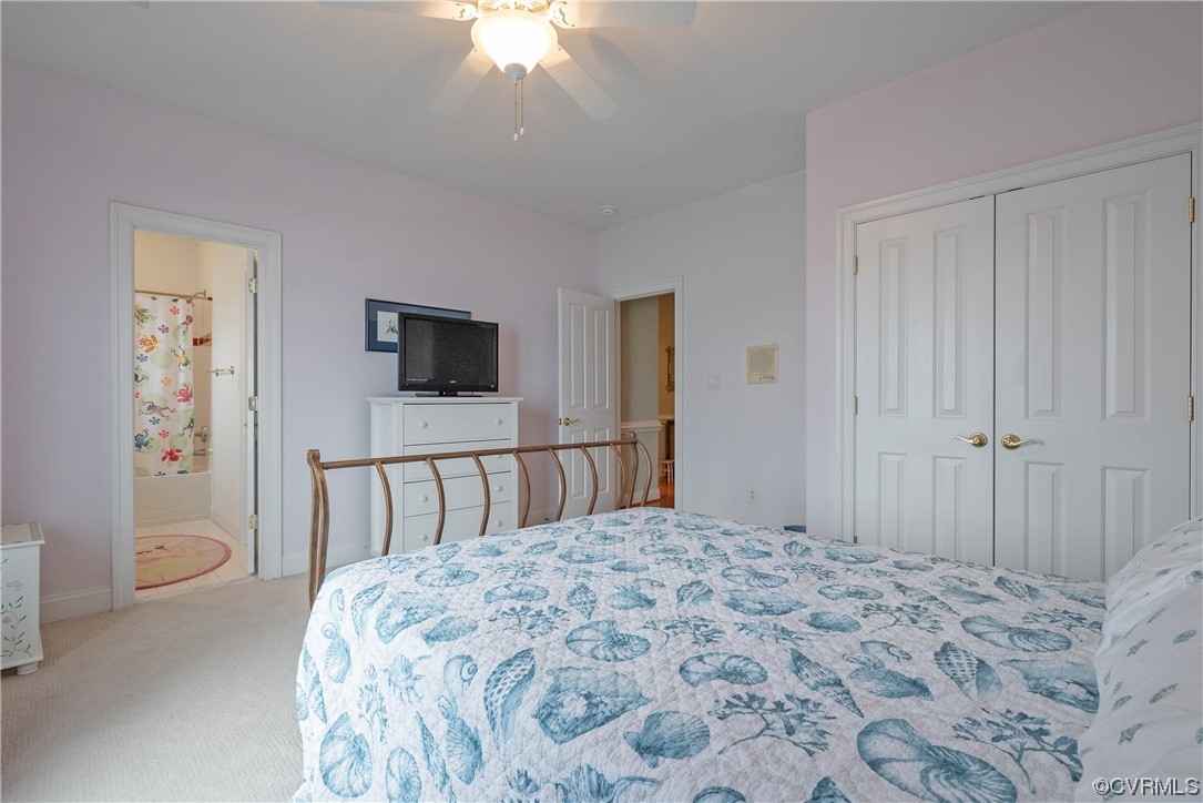 580 Riverside Drive Lancaster, VA 22503 - Photo 36 of 50 a bedroom with a bed and a chandelier