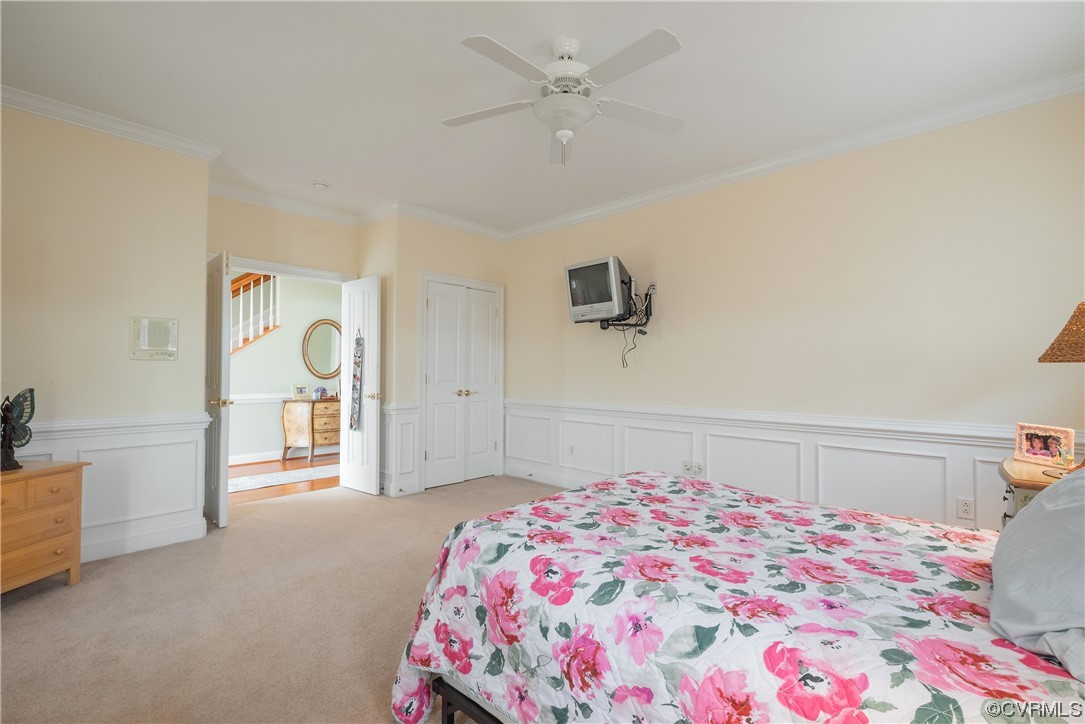 580 Riverside Drive Lancaster, VA 22503 - Photo 10 of 50 a bedroom with a bed and a chandelier
