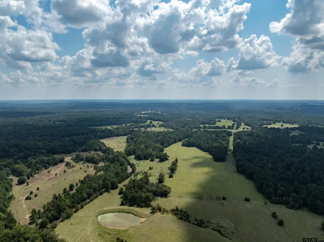 an aerial view of a house with yard