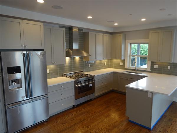 74 F Street, Unit 1 Boston, MA 02127 - Photo 1 of 17 a kitchen with kitchen island granite countertop a sink cabinets and stainless steel appliances
