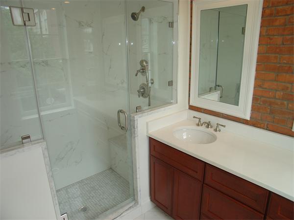 74 F Street, Unit 1 Boston, MA 02127 - Photo 13 of 17 a bathroom with a sink and mirror