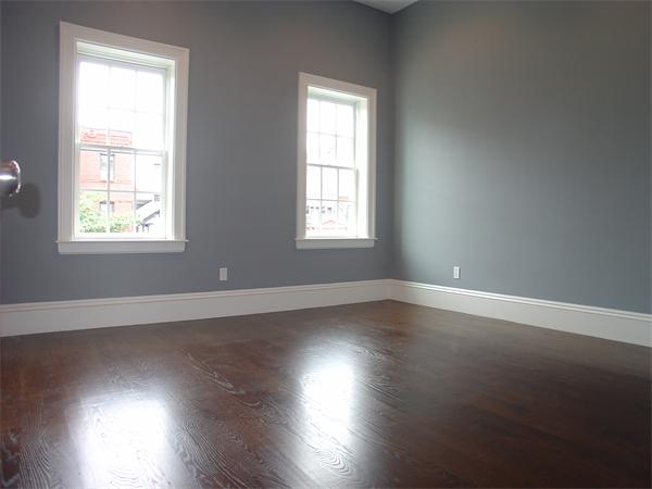 74 F Street, Unit 1 Boston, MA 02127 - Photo 15 of 17 an empty room with wooden floor and windows
