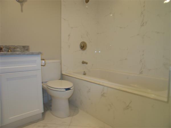 74 F Street, Unit 1 Boston, MA 02127 - Photo 16 of 17 a bathroom with a toilet sink and shower