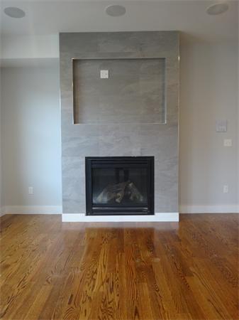 74 F Street, Unit 1 Boston, MA 02127 - Photo 2 of 17 a room with a fireplace