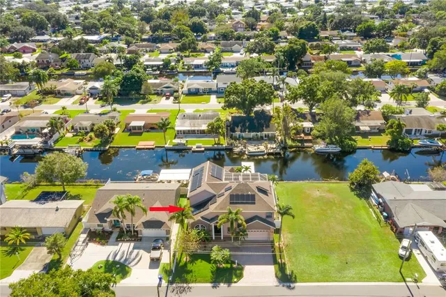 an aerial view of a houses with swimming pool