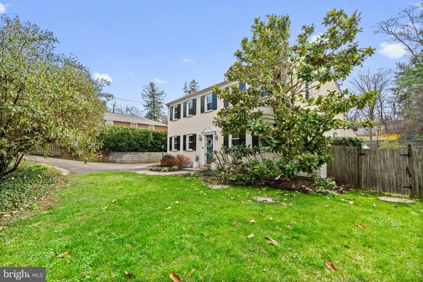 a view of a house with a yard and sitting area