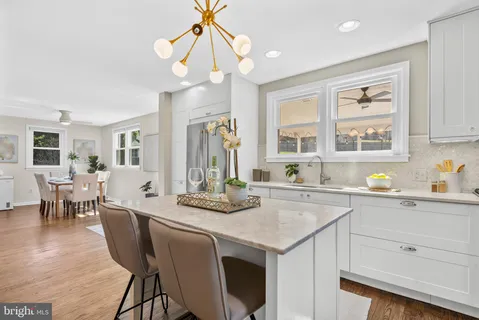 a kitchen with stainless steel appliances granite countertop a sink a stove and refrigerator