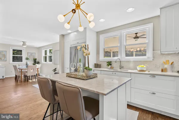 a kitchen with stainless steel appliances granite countertop a sink a stove and refrigerator