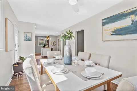 a dining room with furniture and wooden floor