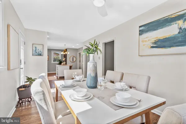 a dining room with furniture and wooden floor