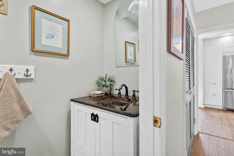 a bathroom with a granite countertop sink