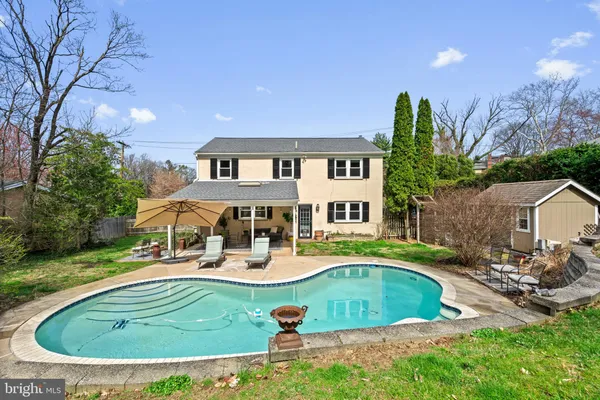 a swimming pool with outdoor seating yard and barbeque oven