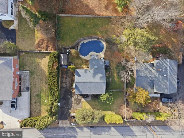 an aerial view of a house with yard swimming pool and outdoor seating