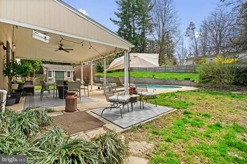 an aerial view of a house with yard swimming pool and outdoor seating