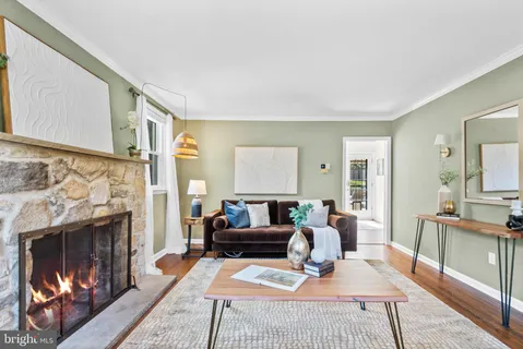 a living room with furniture a fireplace and a table