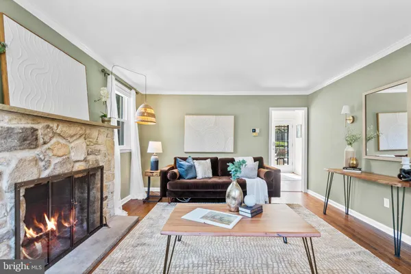 a living room with furniture a fireplace and a table