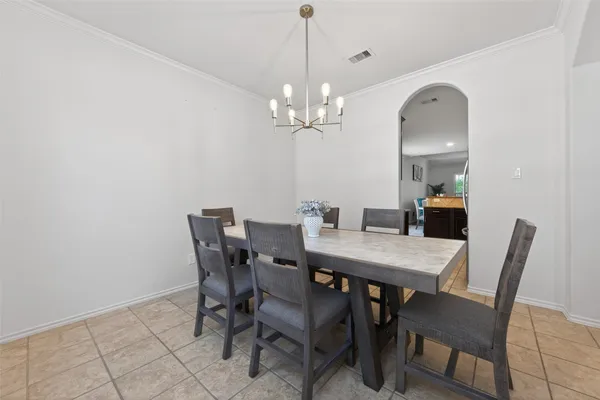 a view of a dining room with furniture and a chandelier