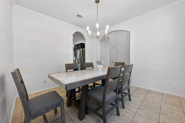 a view of a dining room with furniture and a chandelier