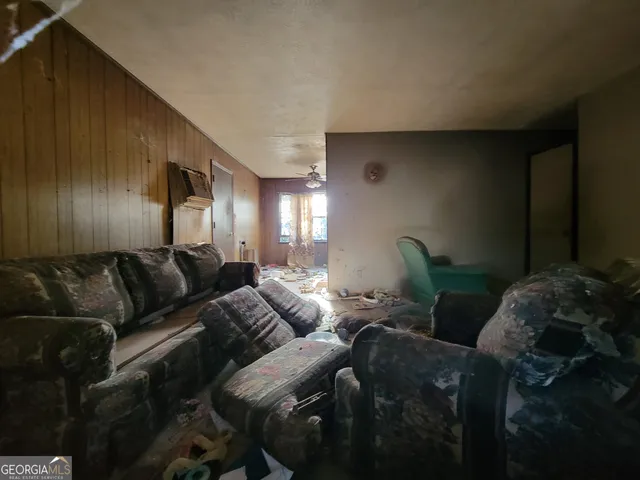 a living room with furniture and a lamp