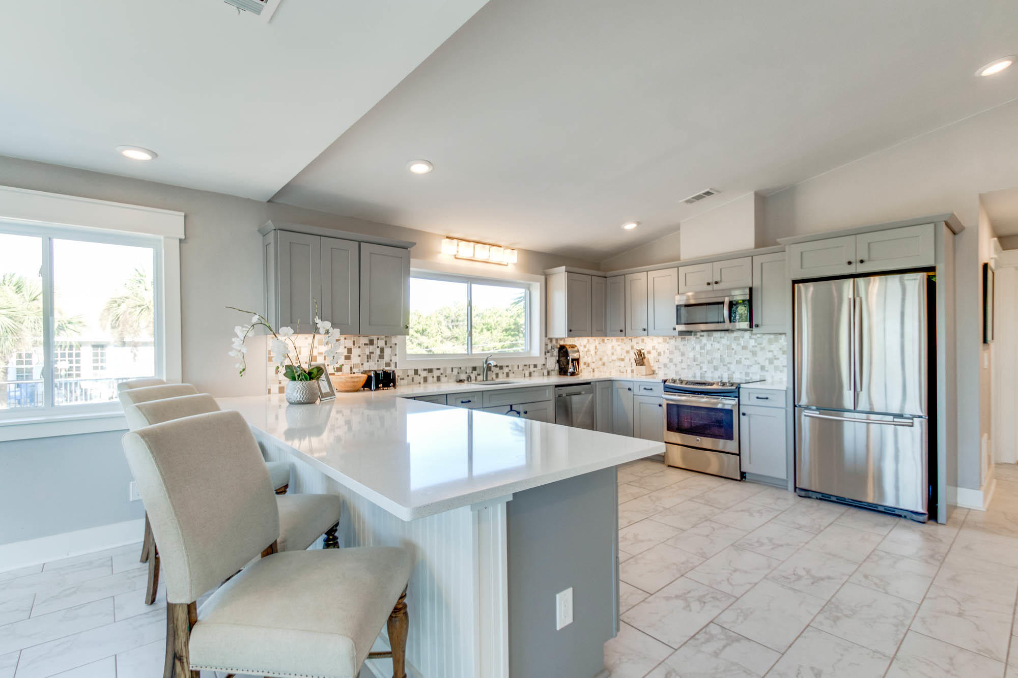74 Pompano Street Inlet Beach, FL 32461 - Photo 5 of 46 a large kitchen with sink a counter space stainless steel appliances and windows
